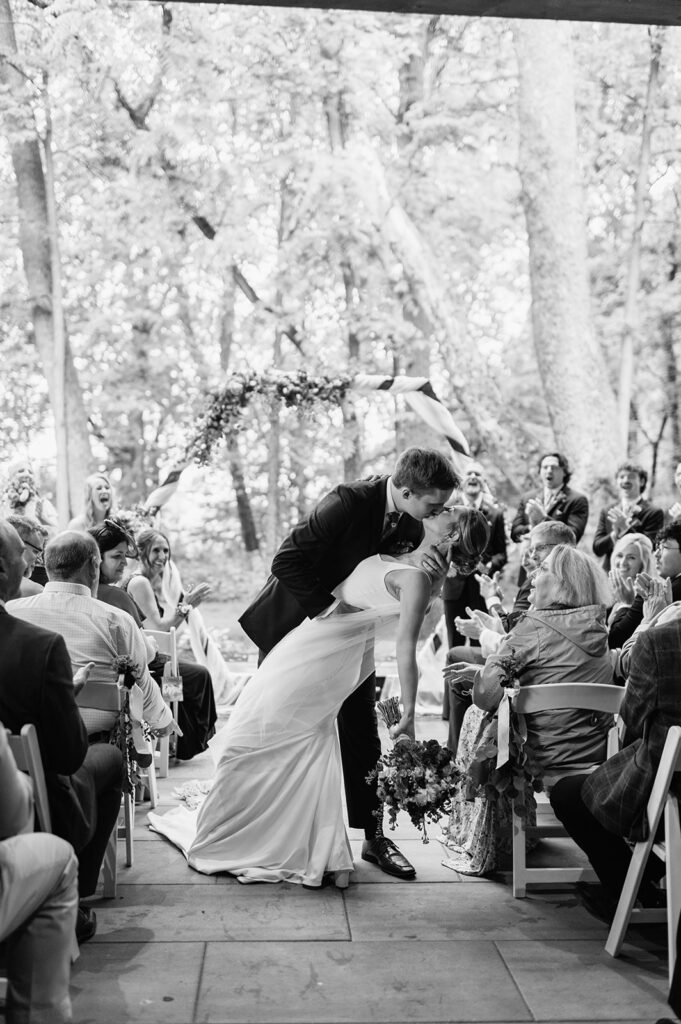 A rainy and colorful outdoor wedding ceremony on the Covered Patio at The Wooded Knot in Tippecanoe, Indiana