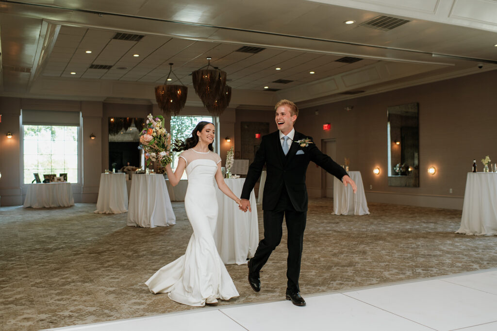 Bride and groom entering their Ritz Charles Carmel, Indiana wedding reception in the Ginkgo Ballroom