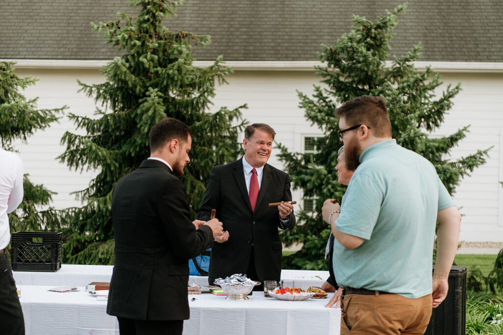 Man rolling cigars during the wedding reception