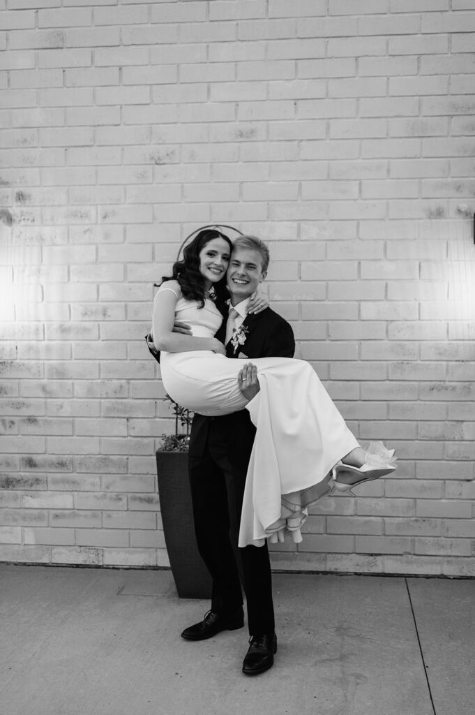 Black and white photo of a bride and groom posing for portraits during their Ritz Charles Carmel, Indiana wedding reception