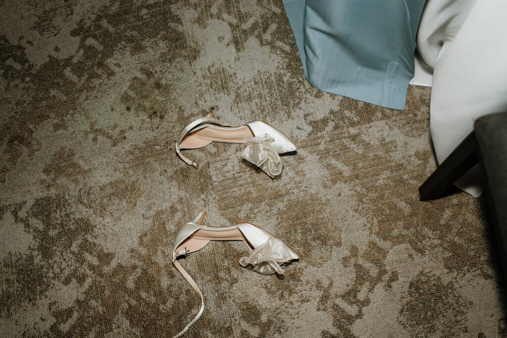 Brides heels off on the floor during their wedding reception