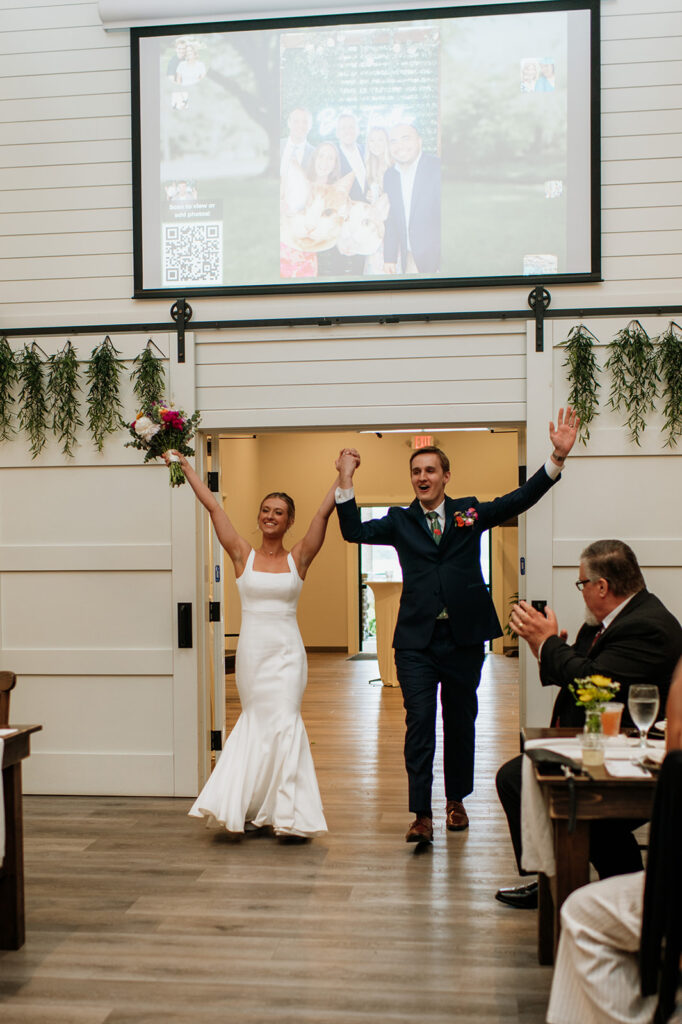 Bride and groom entering their indoor wedding reception at The Wooded Knot in Tippecanoe, Indiana