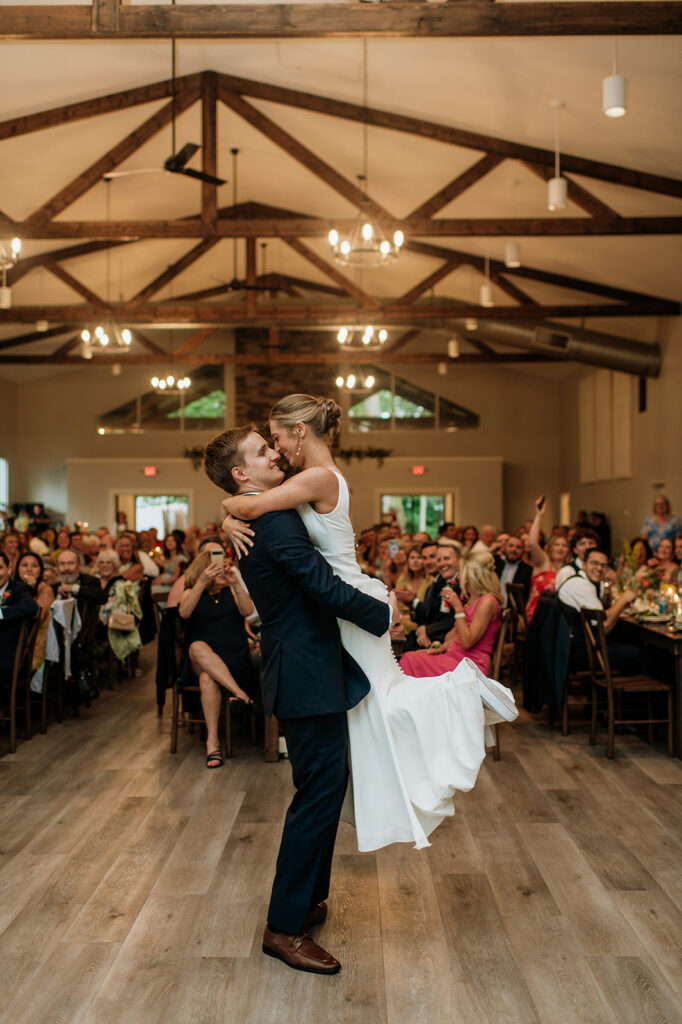 Groom lifting up his bride during their first dance