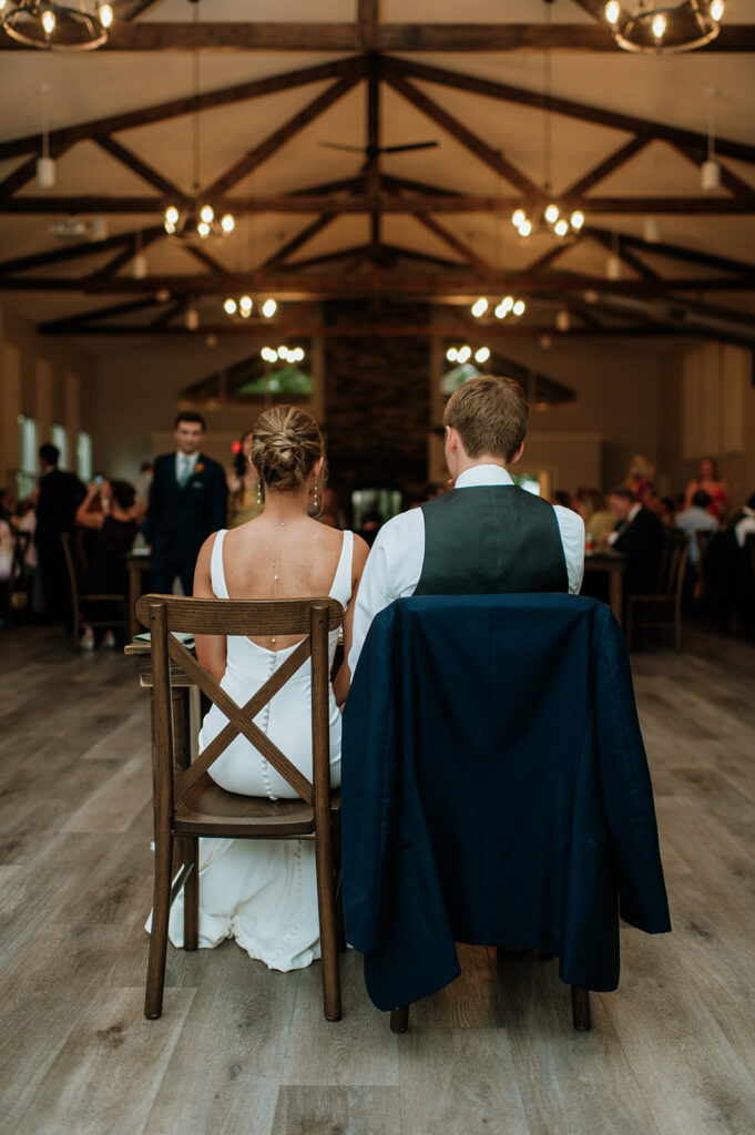 Bride and groom sitting at their table during the reception