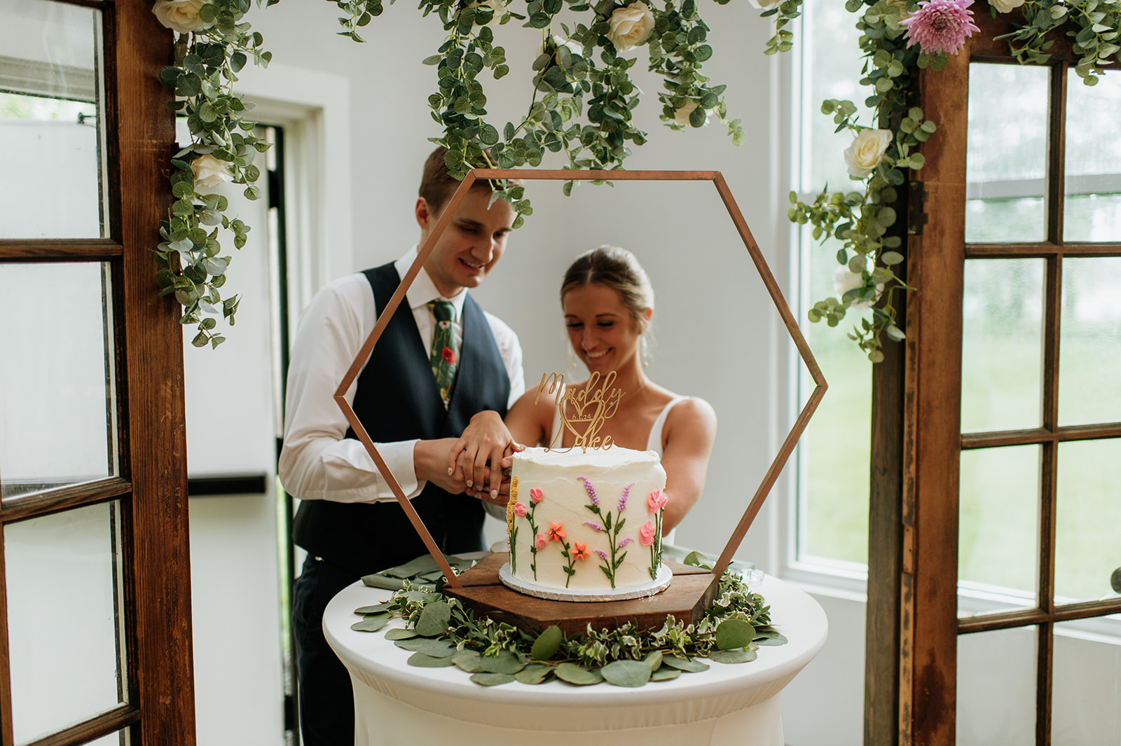 Bride and groom cutting into their wedding cake