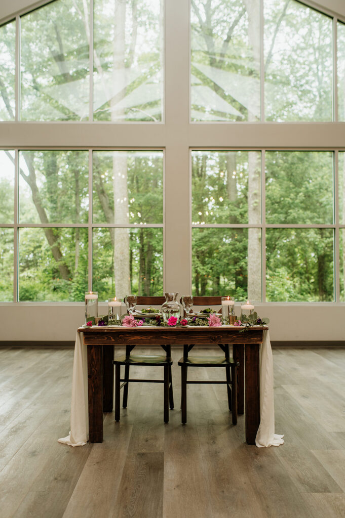 A sweethearts table from an indoor wildflower wedding reception at The Wooded Knot in Tippecanoe, Indiana