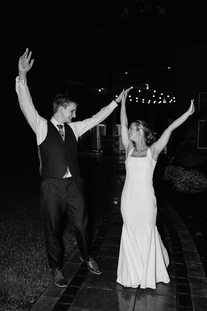 Black and white flash photo of a bride and groom at the end of the night