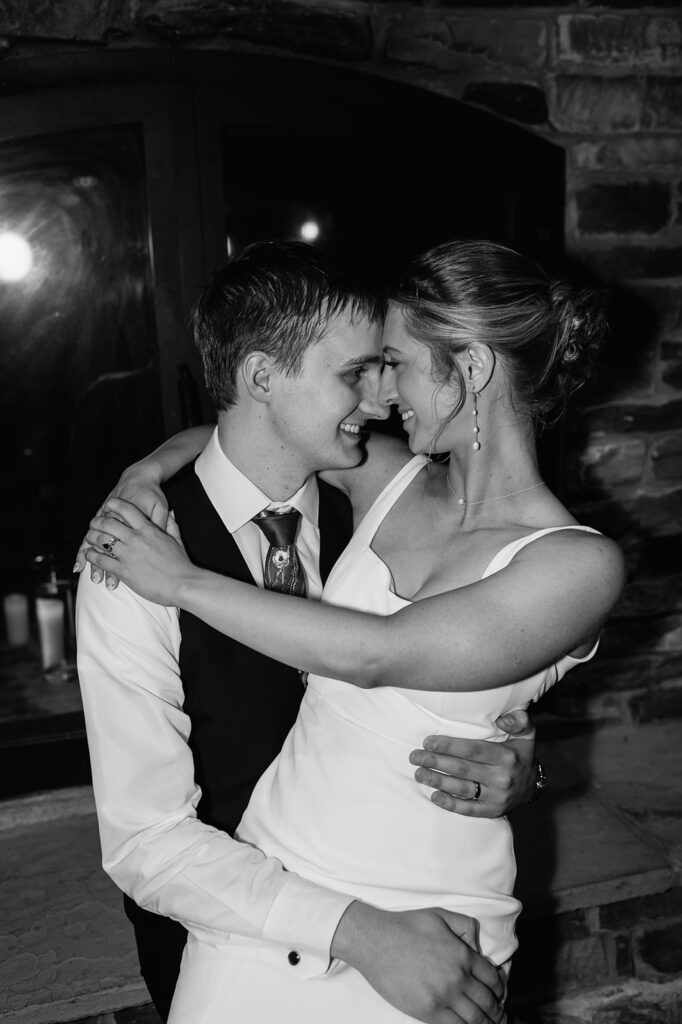 Black and white flash photo of a bride and groom at the end of the night