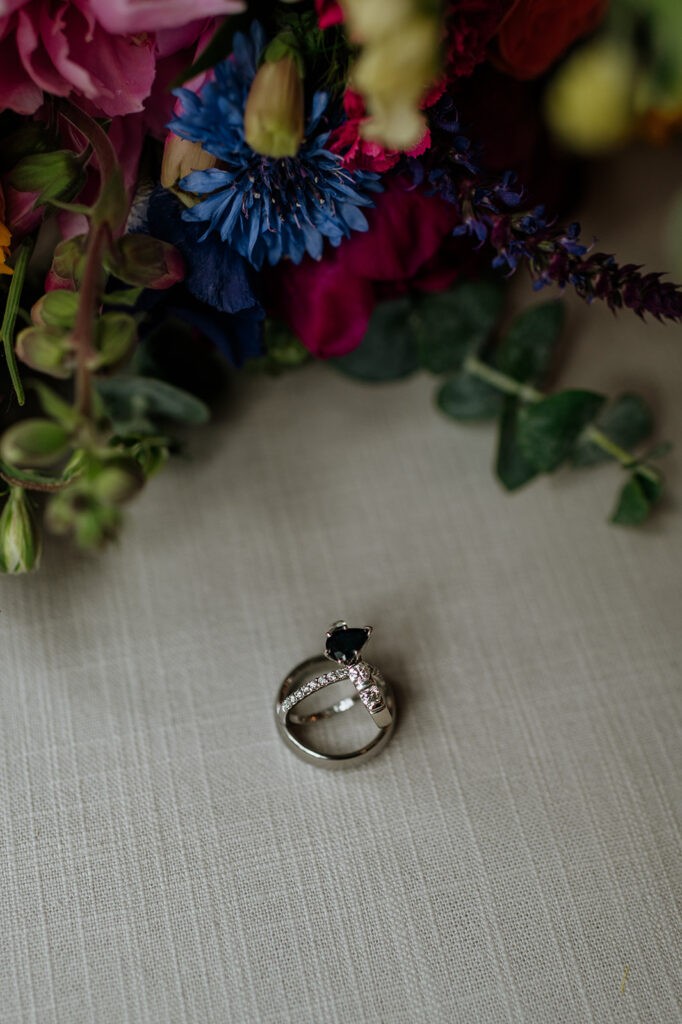 Brides  rings next to a wildflower wedding bouquet