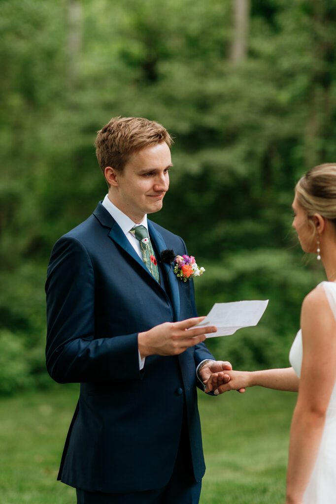 Groom reading his private vows to the bride