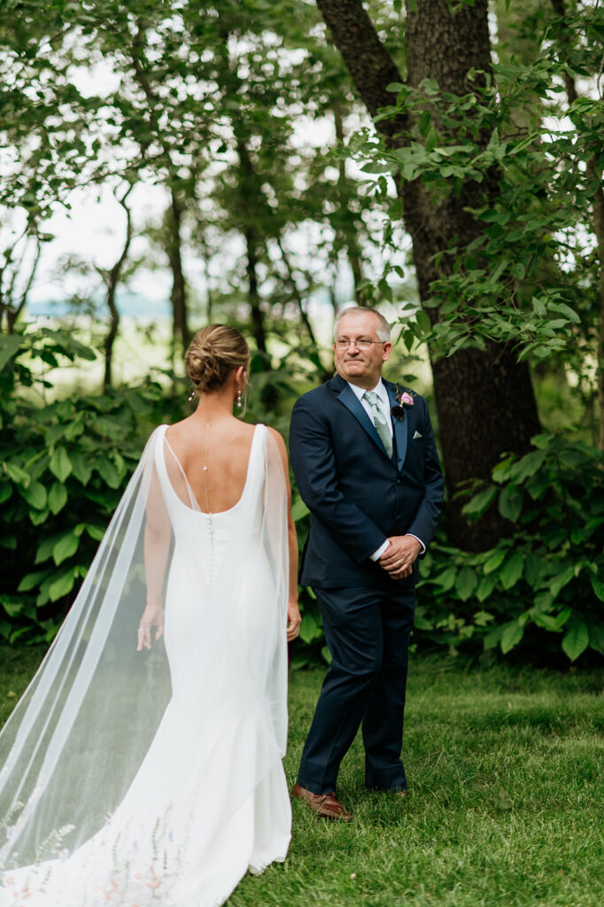 Bride sharing an emotional first look with her father outside