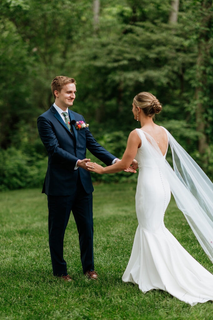 Bride and groom sharing an emotional first look outside