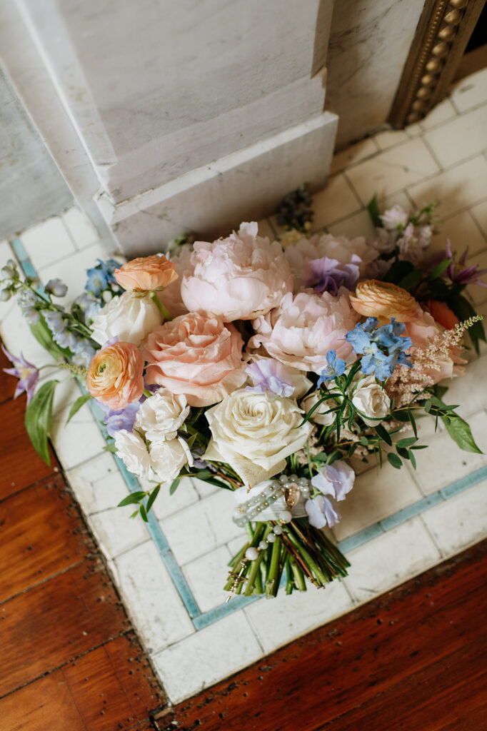 Brides summer wedding bouquet on the floor of a church