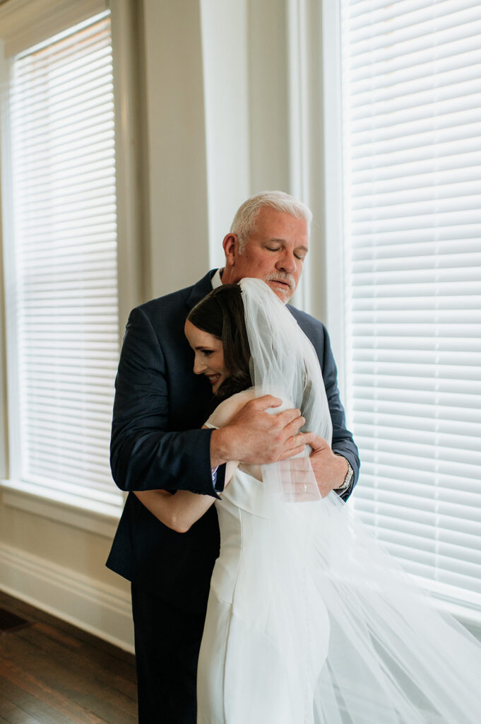 Bride and her father hugging during their first look