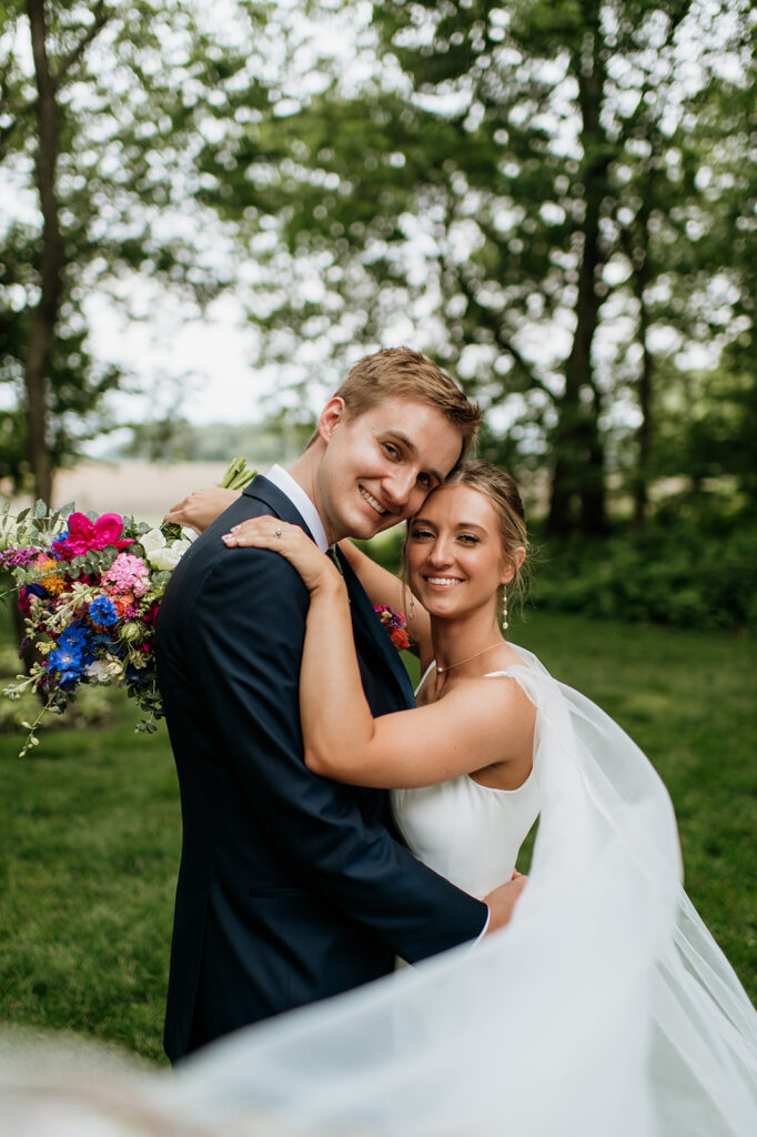 Bride and grooms outdoor wedding portraits from a colorful wildflower wedding at The Wooded Knot in Tippecanoe, Indiana