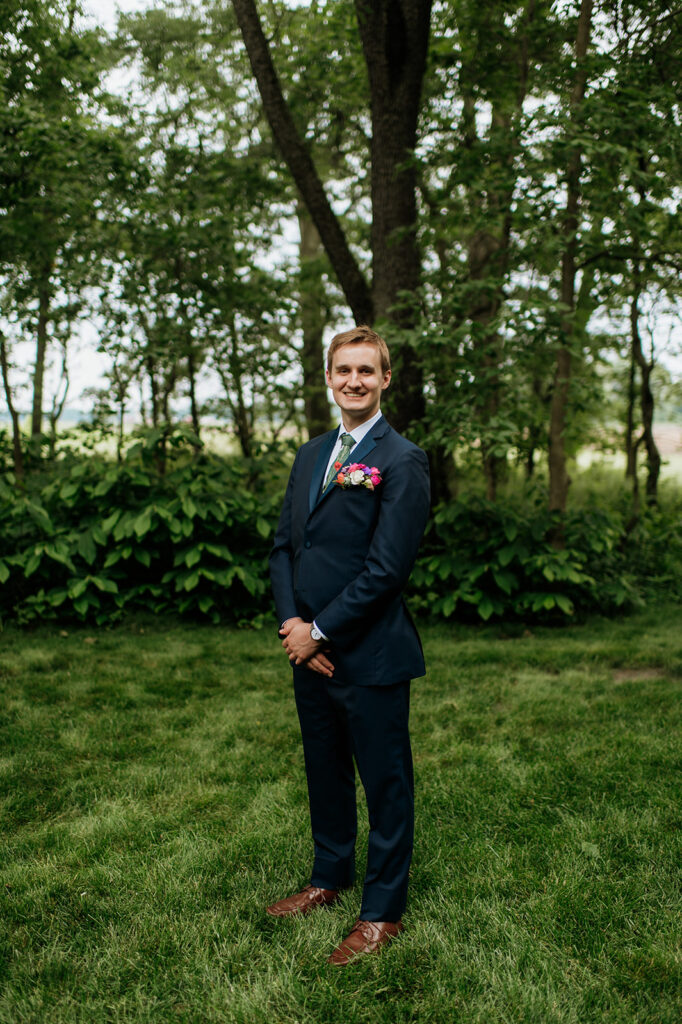 Outdoor grooms portraits from a colorful wildflower wedding at The Wooded Knot in Tippecanoe, Indiana