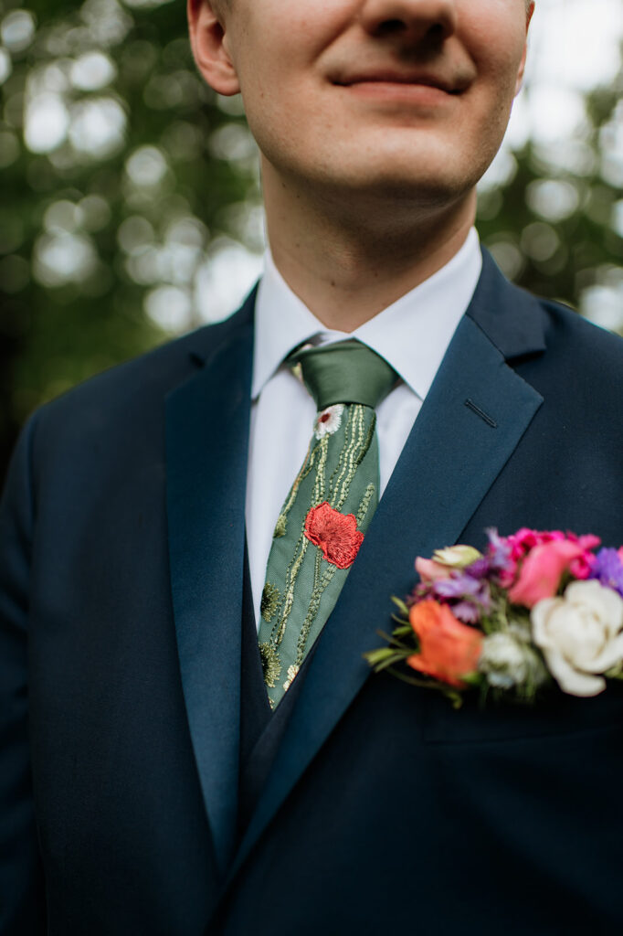 Outdoor grooms portraits from a colorful wildflower wedding at The Wooded Knot in Tippecanoe, Indiana