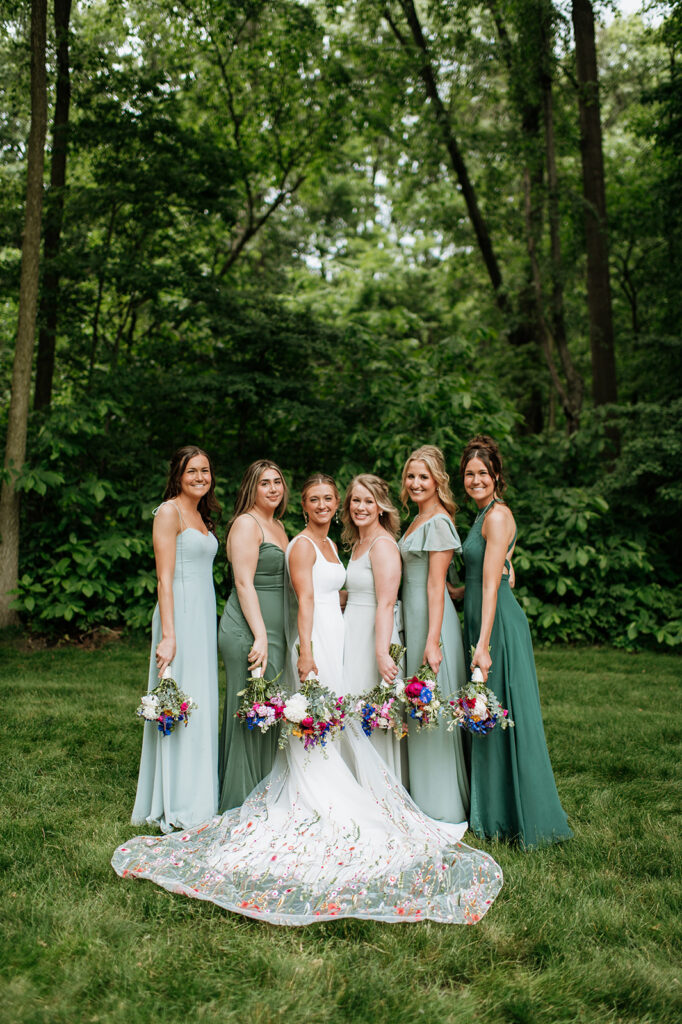 Outdoor bride and bridesmaids photos from a colorful wildflower wedding at The Wooded Knot in Tippecanoe, Indiana