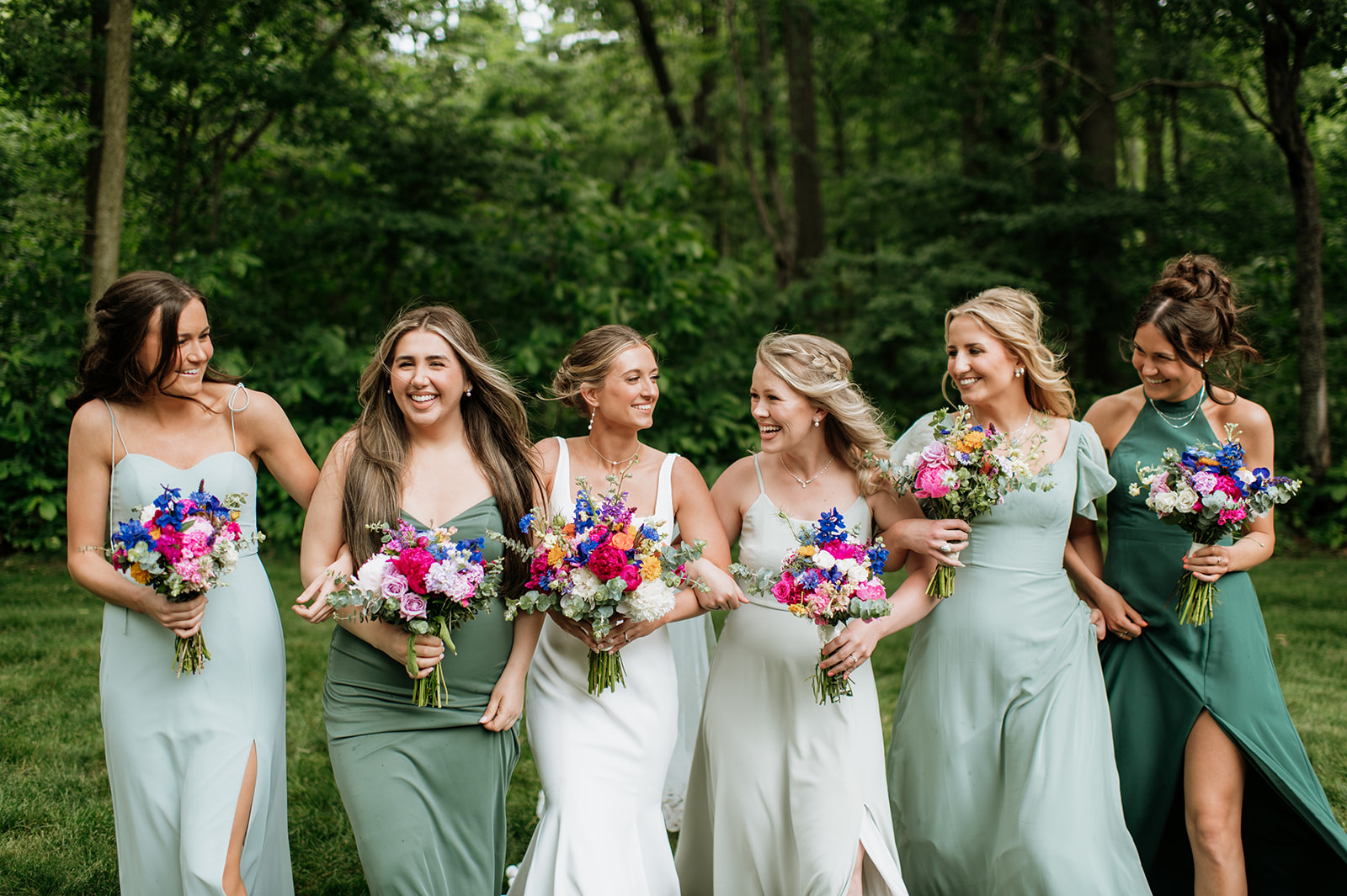 Outdoor bride and bridesmaids photos from a colorful wildflower wedding at The Wooded Knot in Tippecanoe, Indiana