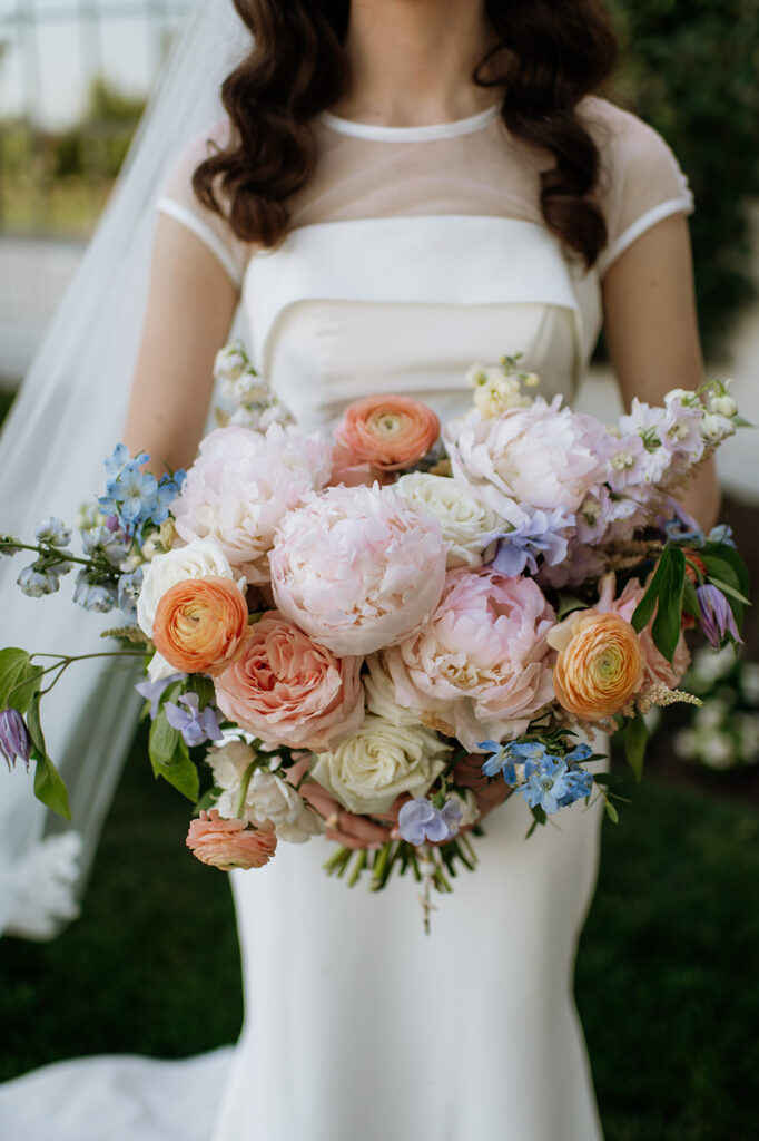 Bride holding a beautiful summer wedding bouquet