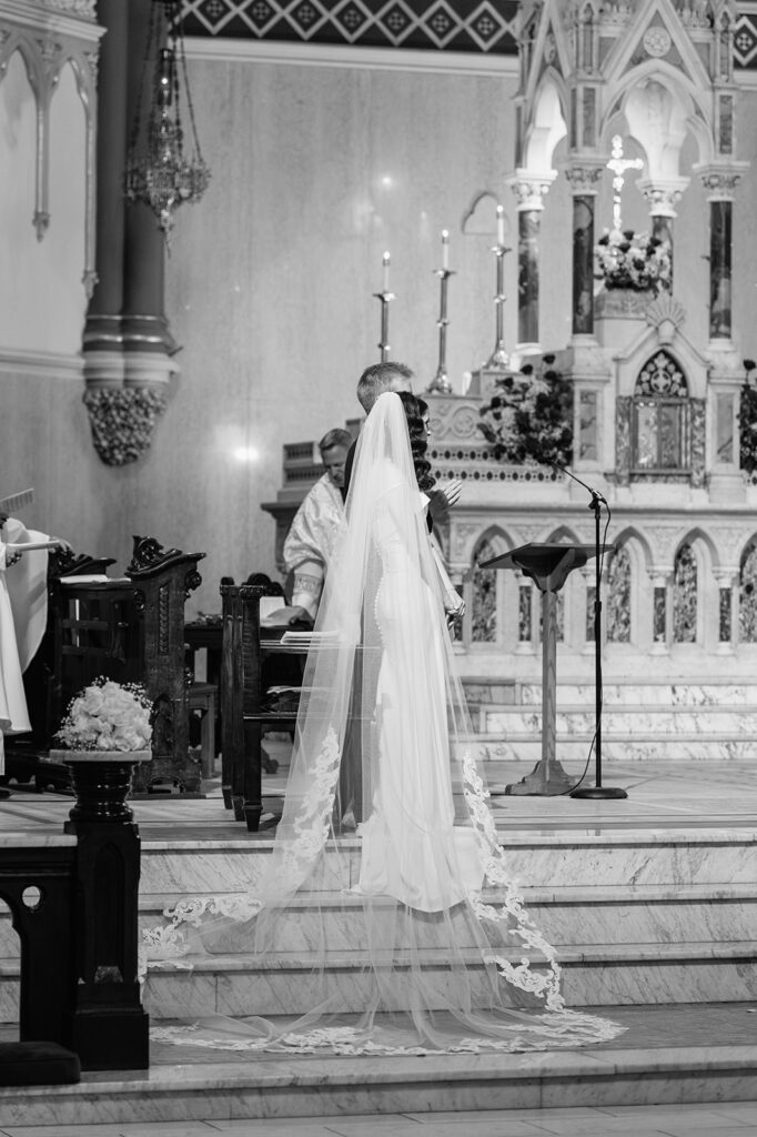 Black and white photo of a St. John the Evangelist Catholic Church wedding ceremony in Indianapolis, Indiana