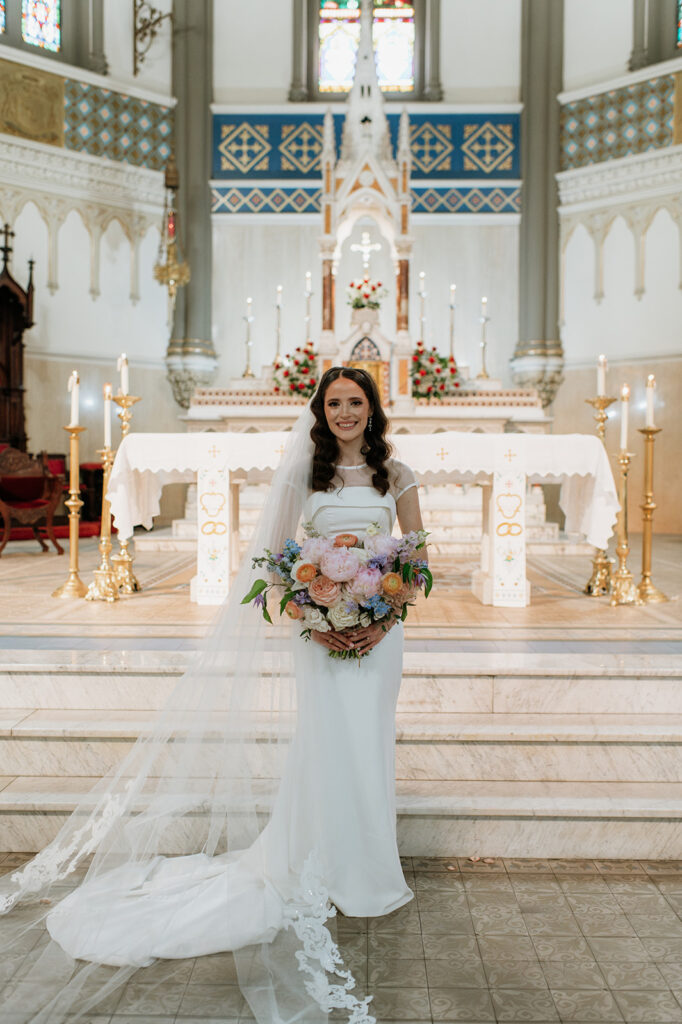 Indoor bridal portraits from a Bride and grooms wedding portraits from their St. John the Evangelist Catholic Church wedding ceremony in Indianapolis, Indiana