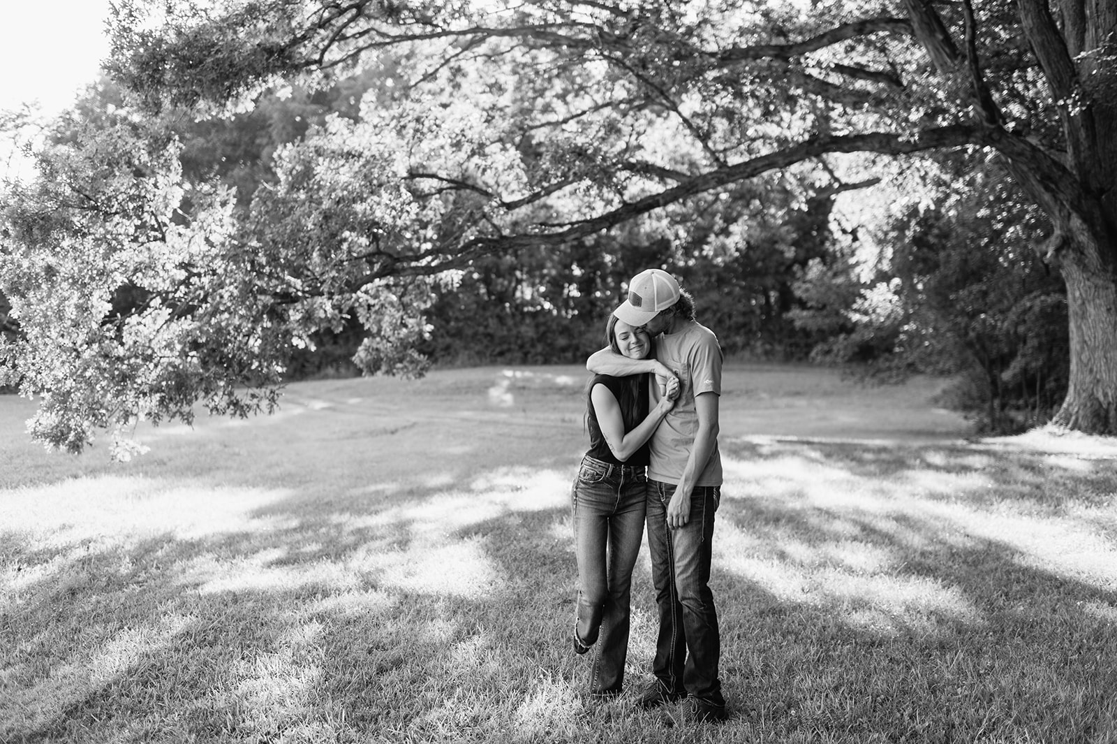 Black and white photo of a couple hugging during their outdoor engagement photos in the Midwest