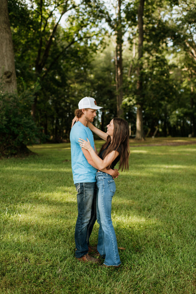 Man and woman posing for their outdoor engagement shoot in Albion, Indiana