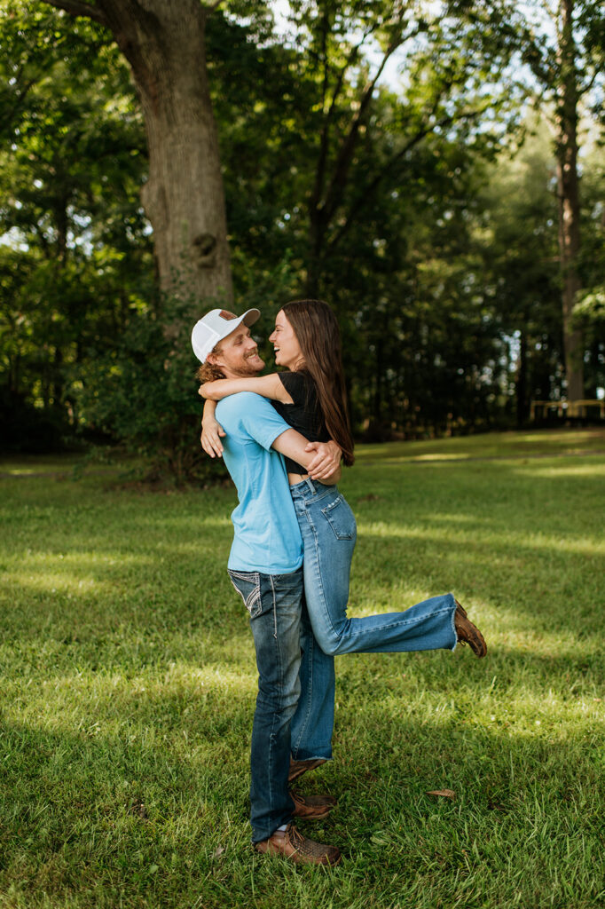 Man picking up his fiancé during their photoshoot