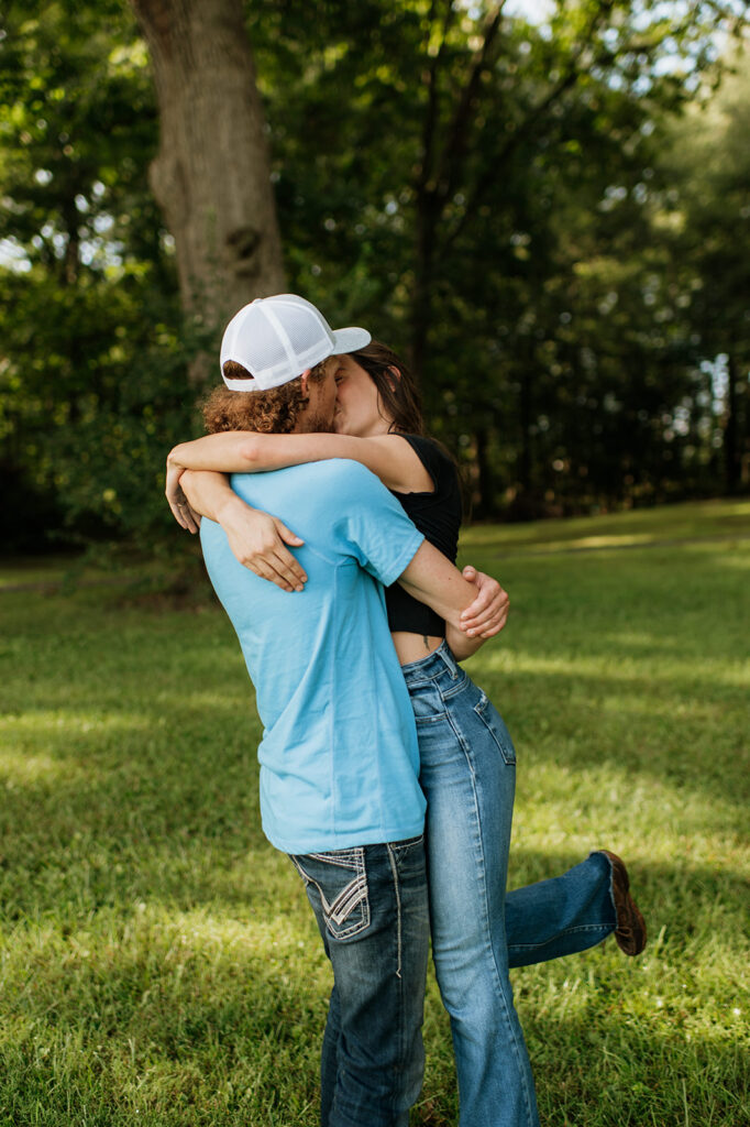 Man and woman kissing during their engagement shoot