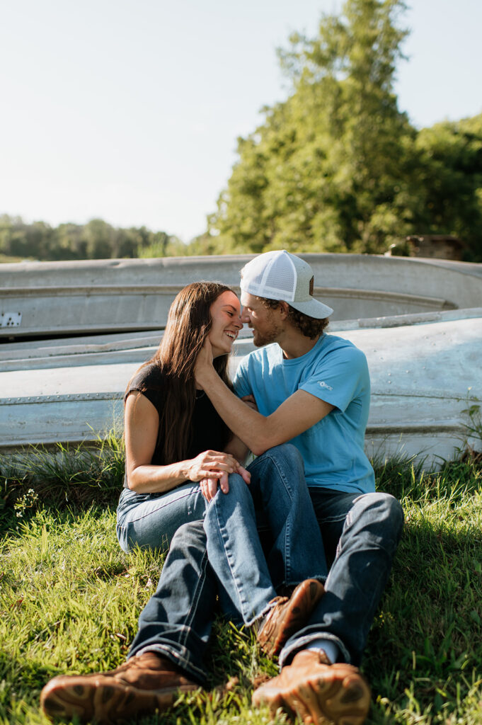 Man and woman sitting next to boats