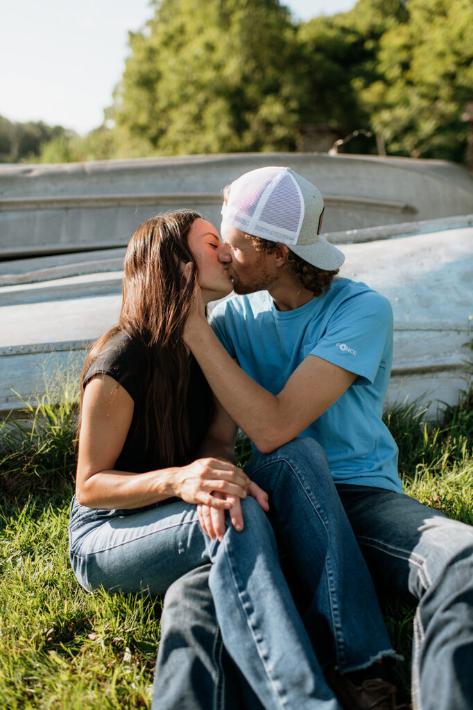 Man and woman kissing as they sit outside