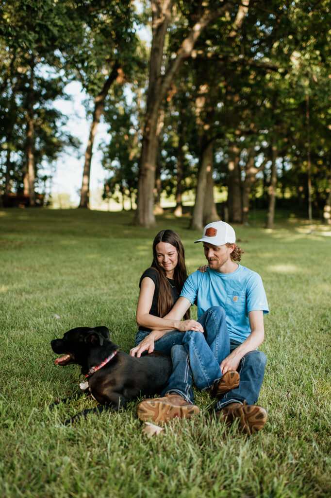 Man and woman petting their dog