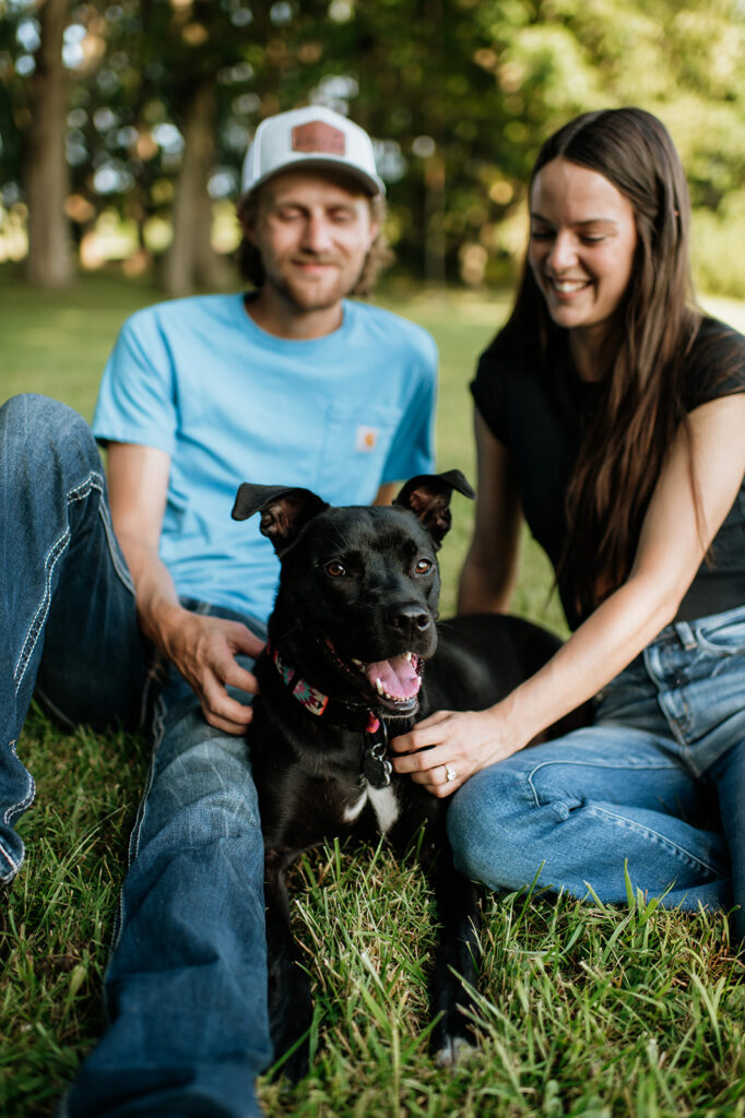 Man and woman petting their dog