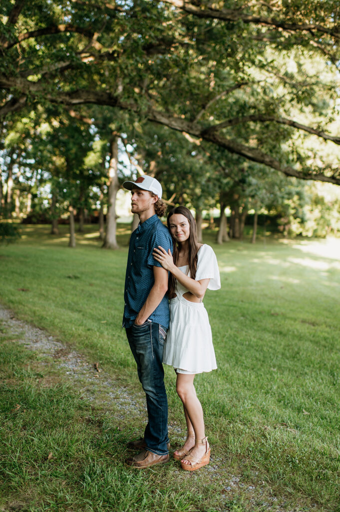 Couple posing for their woodsy outdoor Midwest engagement photos