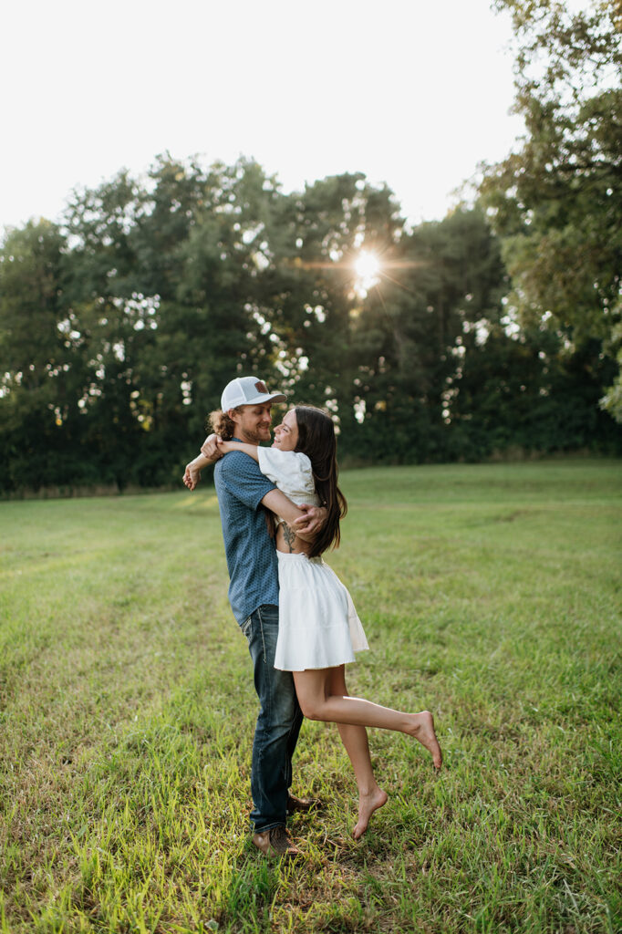 Man picking up his fiancé during their engagement shoot