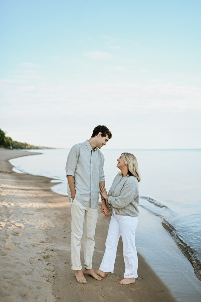 Man and woman's New Buffalo engagement photos after their Michigan surprise proposal