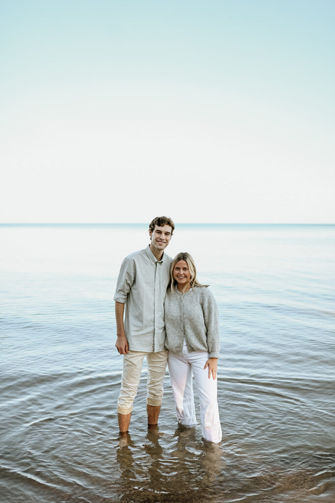 Man and woman posing in the water at Gordon Beach in New Buffalo, Michigan