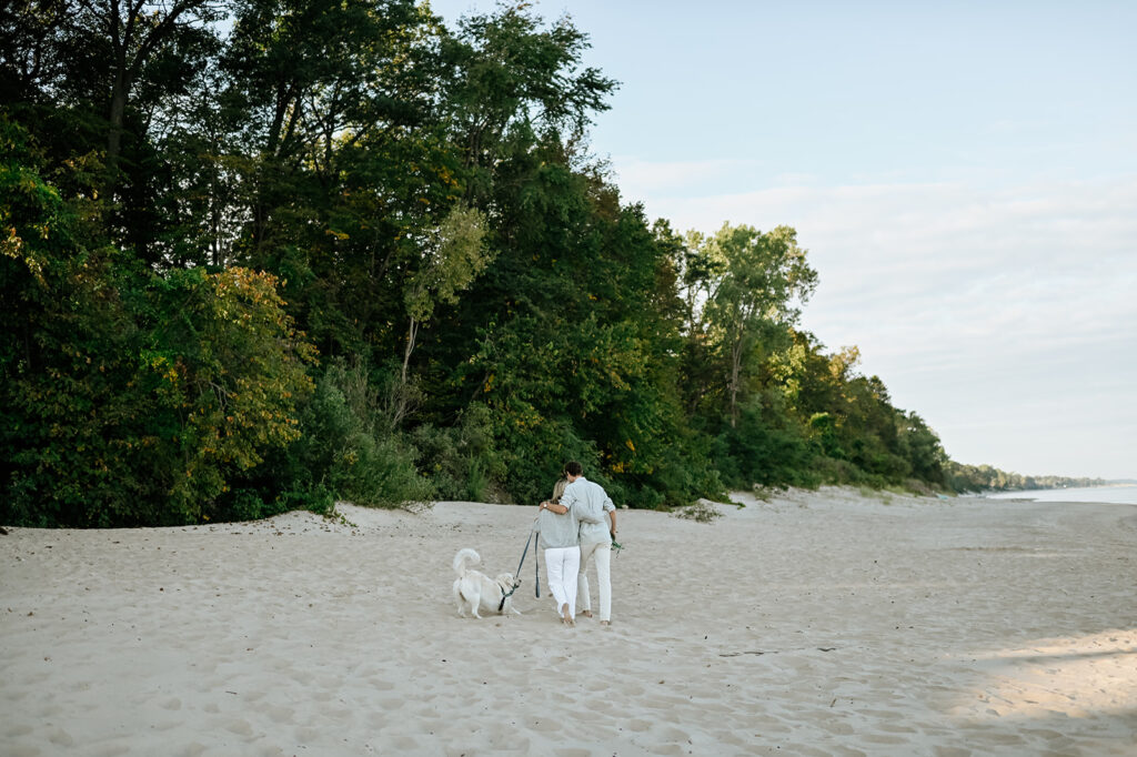 Man, woman and their dog walking Gordon Beach after their surprise proposal