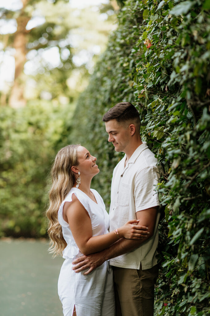 Man and woman smiling at each other during their Indiana engagement shoot