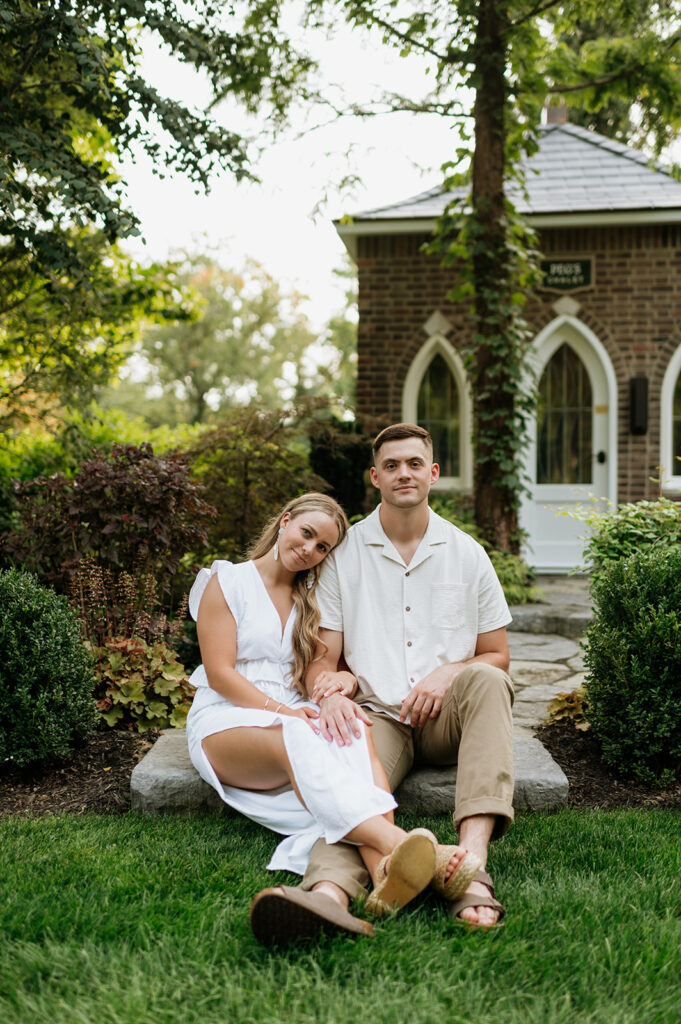 Couple sitting on stone steps for their Indiana engagement shoot