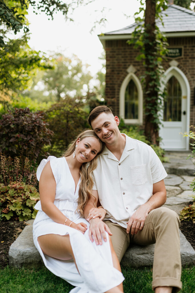 Couple smiling and posing for their Hamstra Gardens engagement session in Wheatfield, Indiana