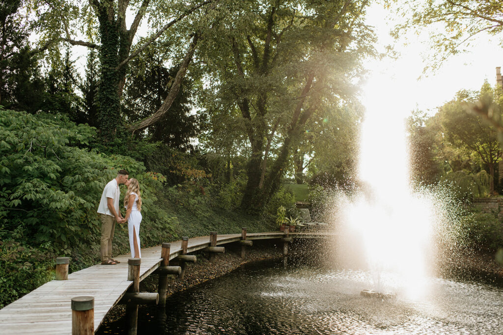 Couple kissing near a water fountain at Hamstra Gardens in Wheatfield, Indiana