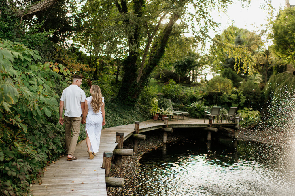 Couple walking near a water fountain at Hamstra Gardens in Wheatfield, Indiana