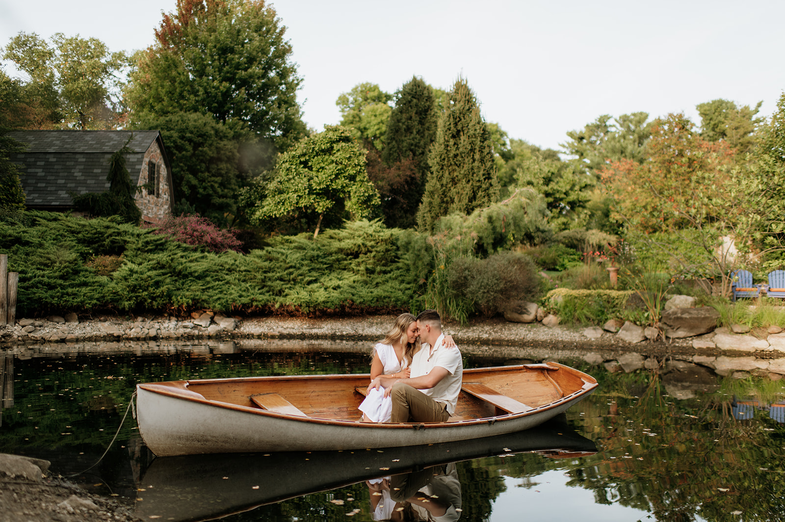 Couple sitting in a canoe during their Hamstra Gardens engagement photos in Wheatfield, Indiana