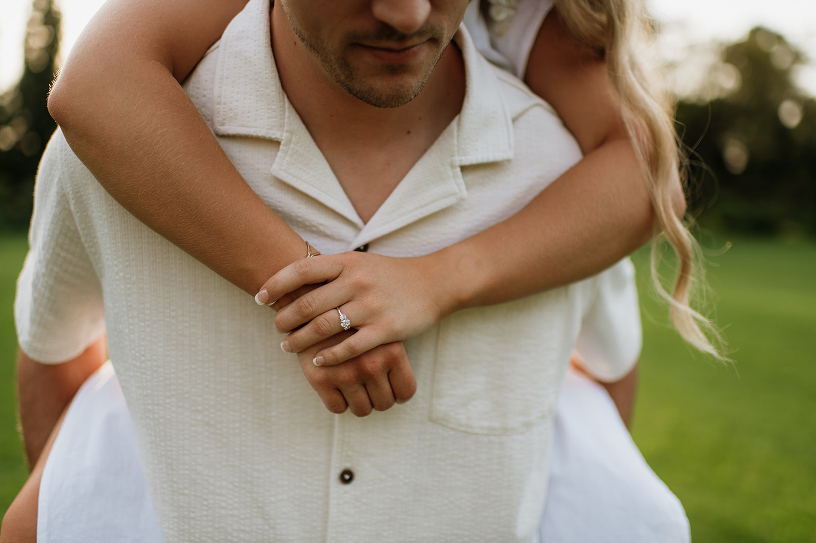 Man giving his fiancé a piggy back ride during their engagement session