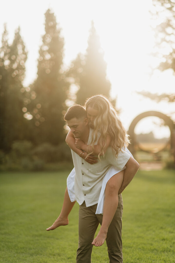 Man giving his fiancé a piggy back ride during their engagement session