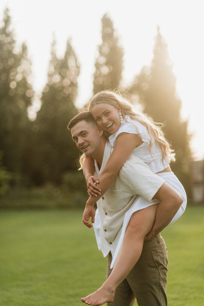 Man giving his fiancé a piggy back ride during their engagement session