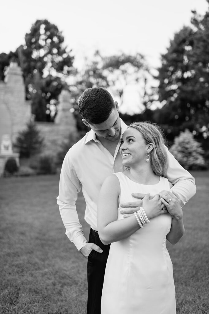 Black and white photo of a couple posing for their engagement photos