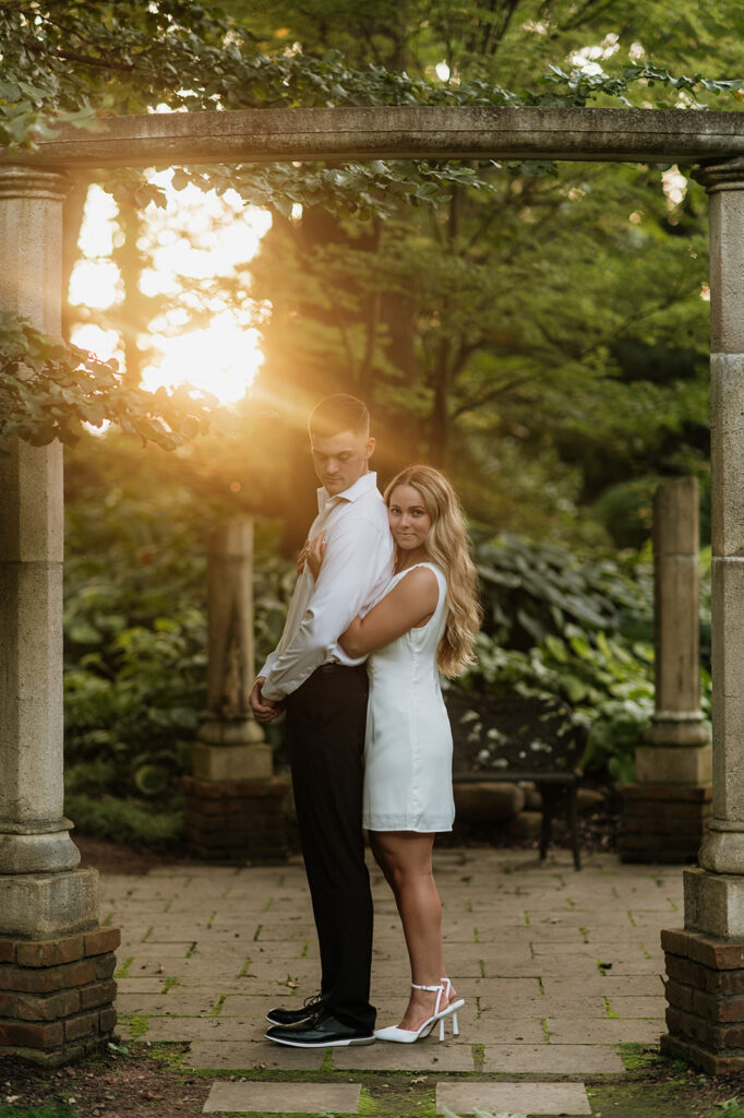 Couple posing during sunset at Hamstra Gardens